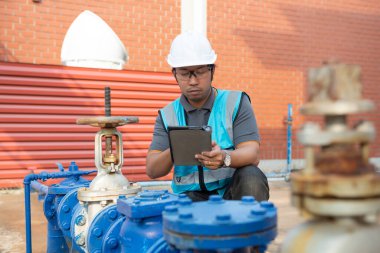 Engineer checking the water supply valve, Plumbing maintenance technicians open and close the main water supply.