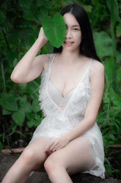 Portrait of sexy asian woman at the waterfall,Feeling fresh at the river,Thai female relax at country