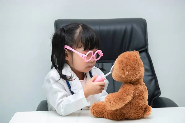 Portrait Cute Asian Little Girl Doctor Uniform Working Desk White — Φωτογραφία Αρχείου