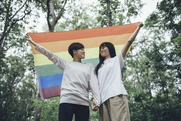 Couple of girl with girl,LGBT Pride month concept,Asian Handsome male make up and wear woman cloth,Gay Freedom Day,Portrait of Non-binary on white background