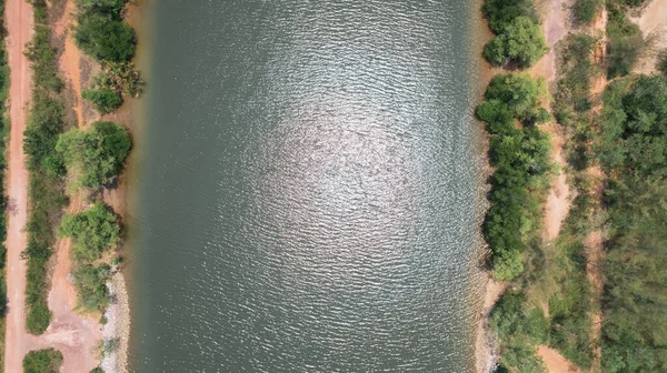 A bird\'s-eye view of the river and mangrove forest from a drone.
