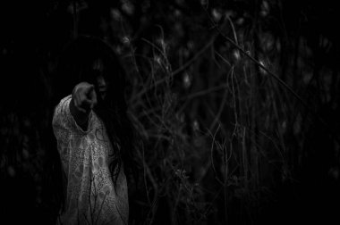 Portrait of asian woman make up ghost face at the swamp,Horror in water scene,Scary at river,Halloween poster,Thailand people