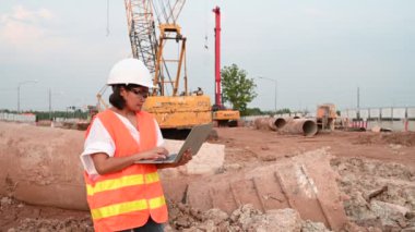 Civil engineer working at a construction site, The company manager supervises the road construction.