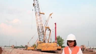 Civil engineer working at a construction site, The company manager supervises the road construction.