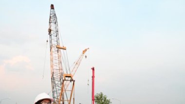 Civil engineer working at a construction site, The company manager supervises the road construction.