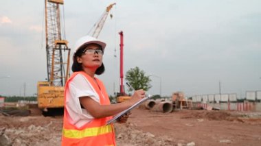 Civil engineer working at a construction site, The company manager supervises the road construction.