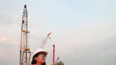 Civil engineer working at a construction site, The company manager supervises the road construction.