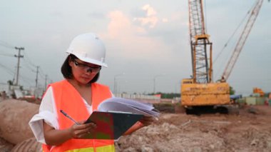 Civil engineer working at a construction site, The company manager supervises the road construction.