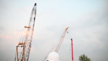 Civil engineer working at a construction site, The company manager supervises the road construction.