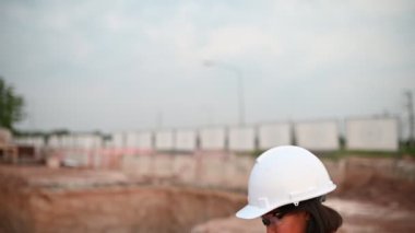 Civil engineer working at a construction site, The company manager supervises the road construction.