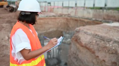 Civil engineer working at a construction site, The company manager supervises the road construction.