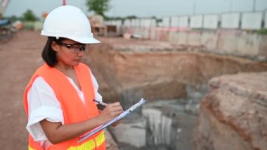 Civil engineer working at a construction site, The company manager supervises the road construction.