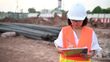 Civil engineer working at a construction site, The company manager supervises the road construction.