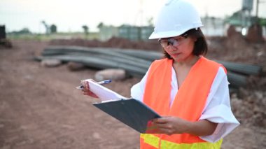 Civil engineer working at a construction site, The company manager supervises the road construction.