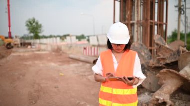 Civil engineer working at a construction site, The company manager supervises the road construction.