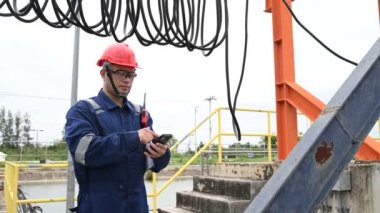 Water plant maintenance technician, mechanical engineer check the control system at the water treatment plant