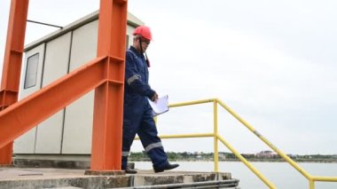 Water plant maintenance technician, mechanical engineer check the control system at the water treatment plant