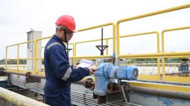 Water plant maintenance technician, mechanical engineer check the control system at the water treatment plant