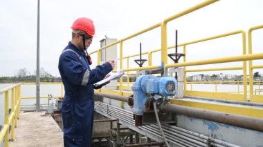 Water plant maintenance technician, mechanical engineer check the control system at the water treatment plant