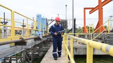 Water plant maintenance technician, mechanical engineer check the control system at the water treatment plant