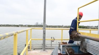 Water plant maintenance technician, mechanical engineer check the control system at the water treatment plant