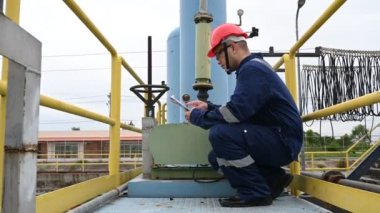 Water plant maintenance technician, mechanical engineer check the control system at the water treatment plant