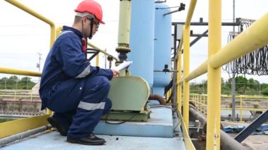 Water plant maintenance technician, mechanical engineer check the control system at the water treatment plant
