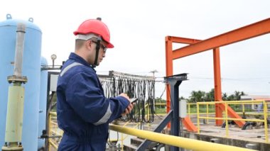 Water plant maintenance technician, mechanical engineer check the control system at the water treatment plant