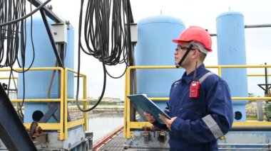 Water plant maintenance technician, mechanical engineer check the control system at the water treatment plant