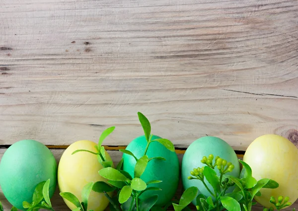 Easter eggs on wooden background with space for text — Stock Photo, Image