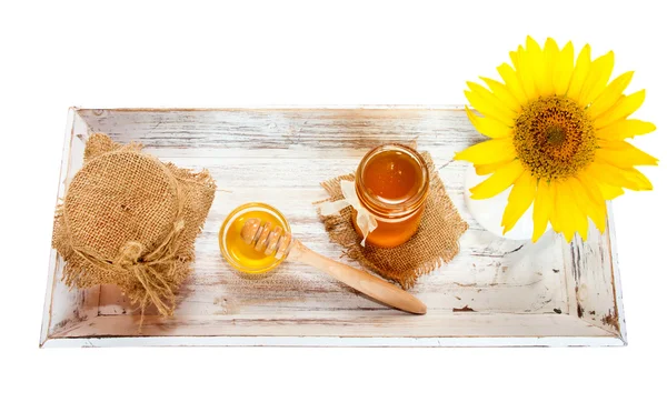 Honey jar, glass bowl on wooden tray.Isolated. — Stock Photo, Image