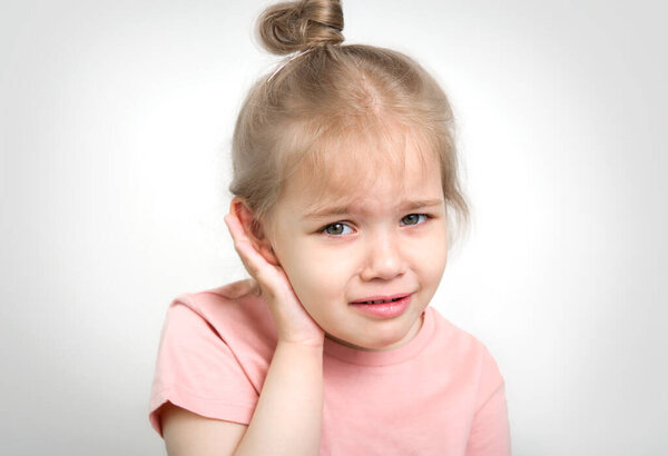 Child with earache, toddler girl portrait ear pain concept. Kid with medical problems.