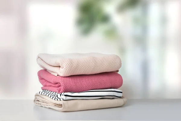 Soft pink stacked knitted clothing.Stack of clothes.Laundry.Fresh washed textile.