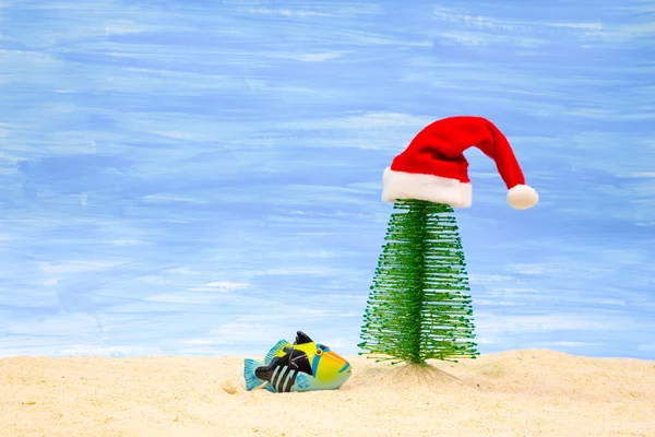 Fish, Christmas tree and red  Santa Claus hat — Stock Photo, Image