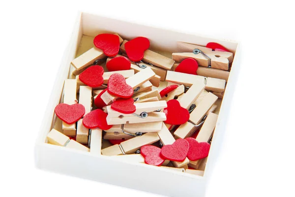 Groups of heart-shaped clothes pin in a box on white — Stock Photo, Image