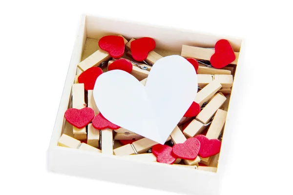 Groups of heart-shaped clothes pin in a box on white — Stock Photo, Image