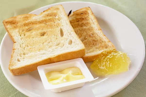 Bread, butter and jam for breakfast — Stock Photo, Image