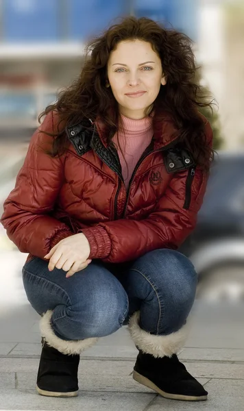 Retrato de mujeres europeas jóvenes y bonitas en chaqueta roja y jeans azules . — Foto de Stock