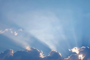 Fantastic Sunbeam Shining Through the Fluffy Clouds