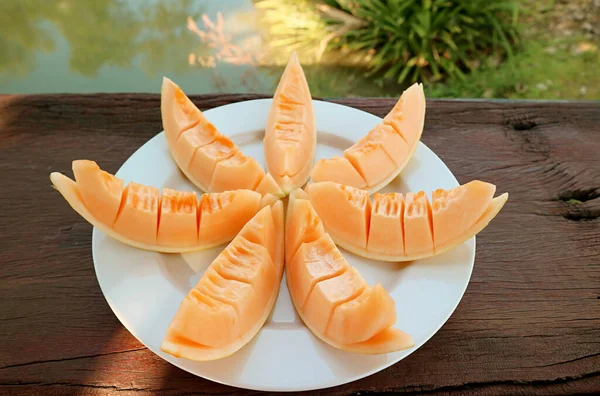 Płyta Plastrów Mouthwatering Fresh Cantaloupe Melon Ogrodzie Drewniany Stół — Zdjęcie stockowe