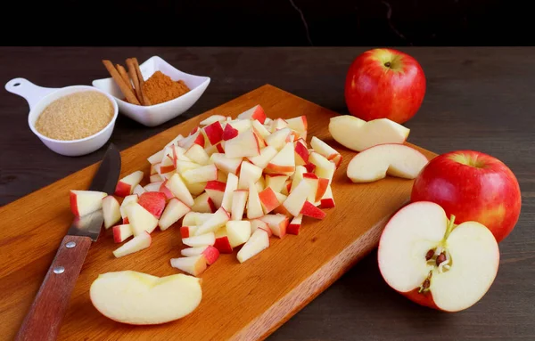 Heap of diced fresh apples on wooden chopping board for making apple compote