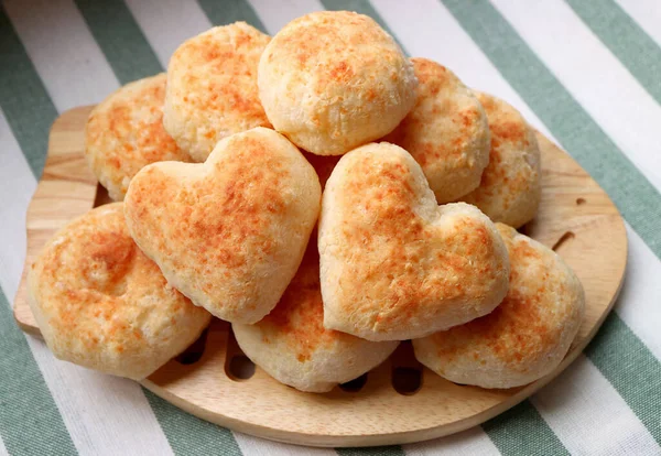 Freshly Baked Homemade Brazilian Cheese Breads or Pao de Queijo with Pair of Heart Shaped on Top