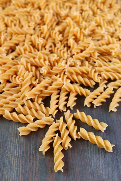 Pile Uncooked Whole Wheat Fusilli Pasta Scattered Black Wooden Background — Stock Photo, Image