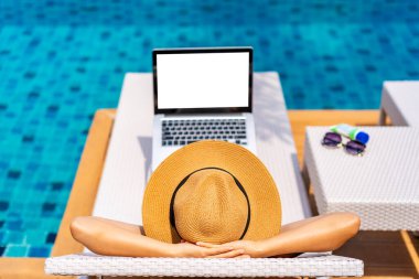 Young woman freelancer traveler working online using laptop while traveling on summer vacation, Freelance and workation concept