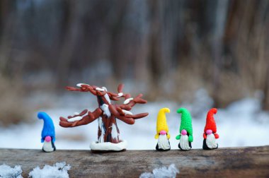 Cüce figürlerine yakın çekim. Yanındaki de plastik ağaçtan yapılmış bir oyuncak..