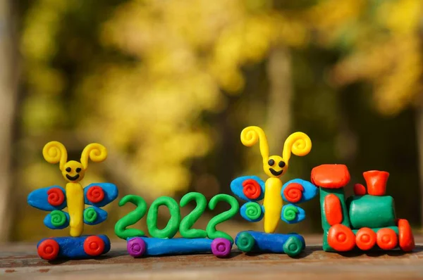 A toy train with fairy-tale characters and the number 2022. A symbol of the new year.