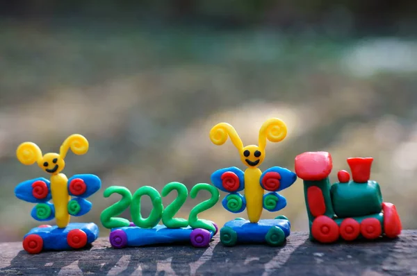 A toy train with fairy-tale characters and the number 2022. A symbol of the new year.