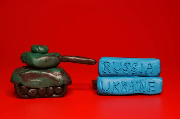 Toy Tank Made Plate Red Background Next Inscription Russia Ukraine — Stock Photo, Image