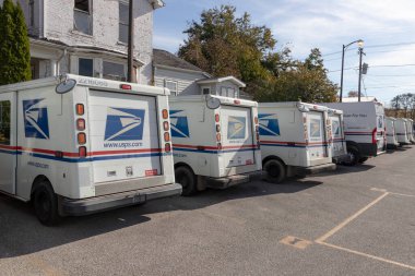 Peru - Circa November 2021: USPS Post Office Mail Trucks. The Post Office is responsible for providing mail delivery. clipart