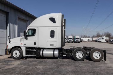 Indianapolis - Circa January 2022: Freightliner Semi Tractor Trailer Trucks Lined up for sale. Freightliner is owned by Daimler.